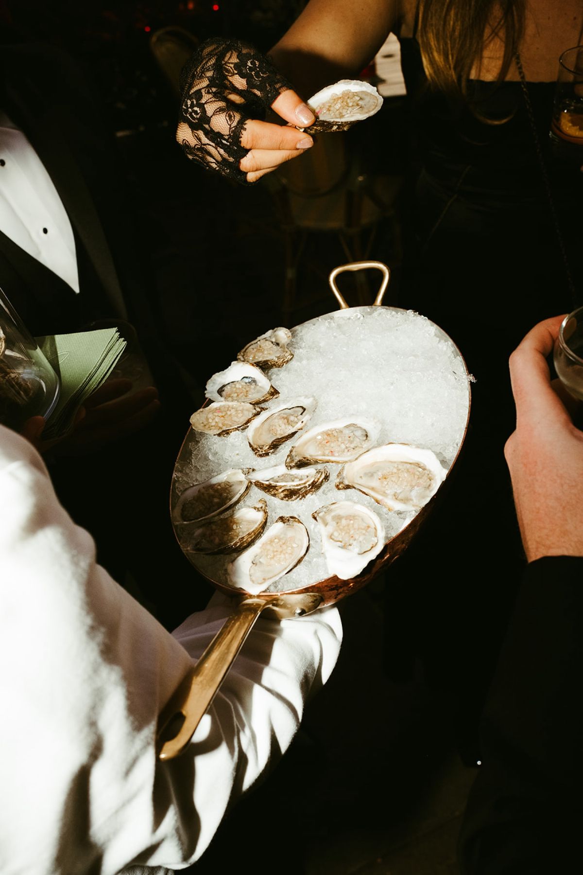 Wedding cocktail hour inspiration featuring oysters on the half shell, similar to menus curated by Well-Dressed Events
