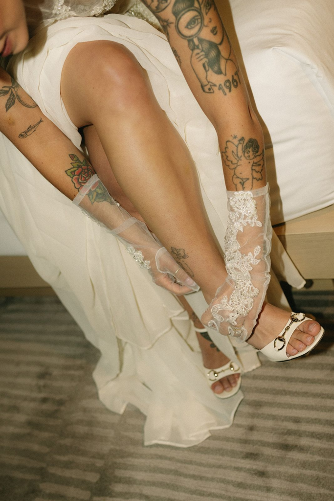 Bride fastening her wedding shoes while getting ready before her New Jersey wedding ceremony.